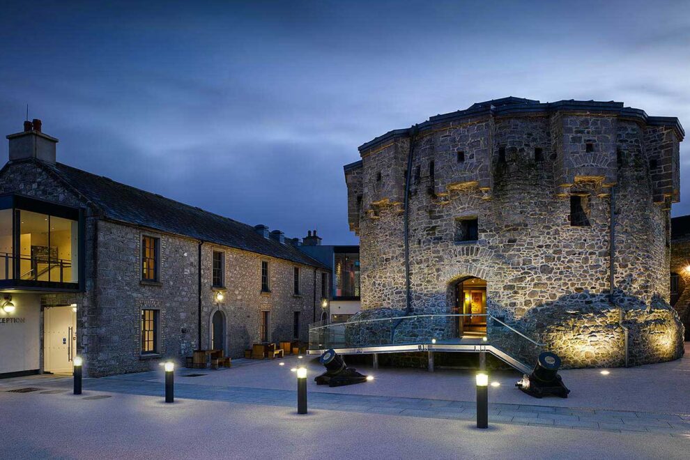 The old castle keep in the courtyard beautifully lit up on a dark evening at Athlone Castle Visitor Centre.