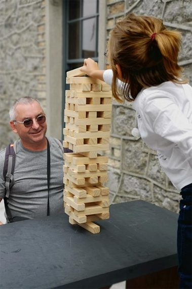 Visitors to Athlone Castle enjoying a game of Tumble Tower at the picnic benches in the courtyard at Athlone Castle during the Traditional Games Day.