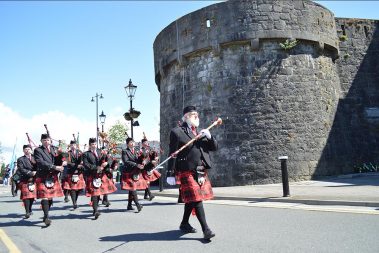 Pipe band in full uniform march by Athlone Castle preforming some uplifting music during the unveiling of the War Memorial outside Athlone Castle Visitor Centre.